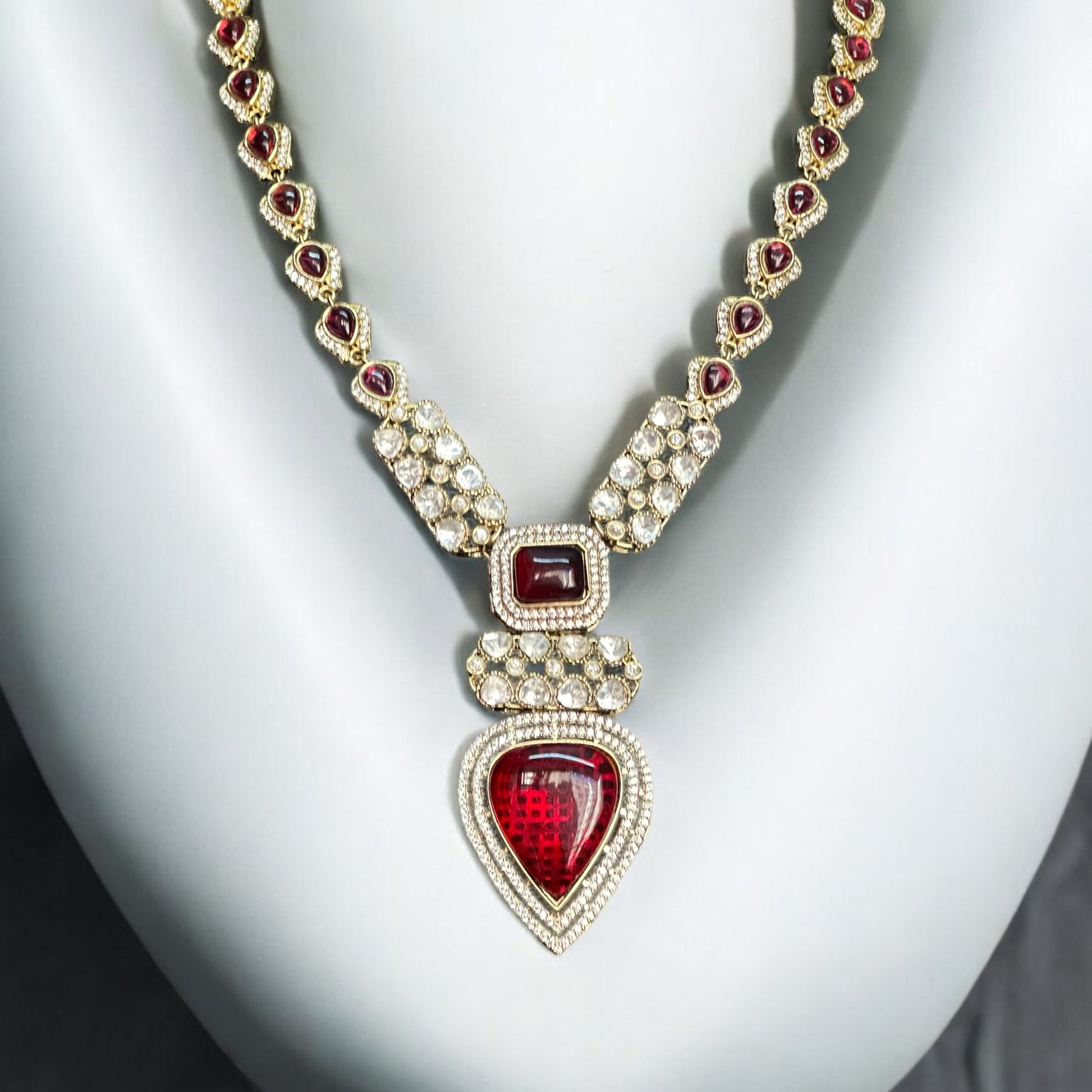 Real Moissanite Kundan Long Necklace with red gemstones, featuring a pear-shaped pendant and intricate detailing.