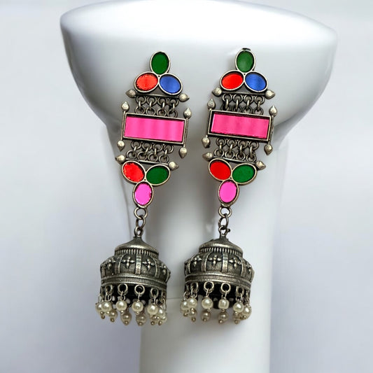 German silver earrings with colorful glass inlays in pink, green, blue, and red, featuring a jhumka design with pearl accents.