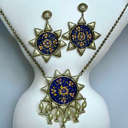 Oxidized silver replica necklace with large blue floral pendant and matching earrings on mannequin – Bella & Diva