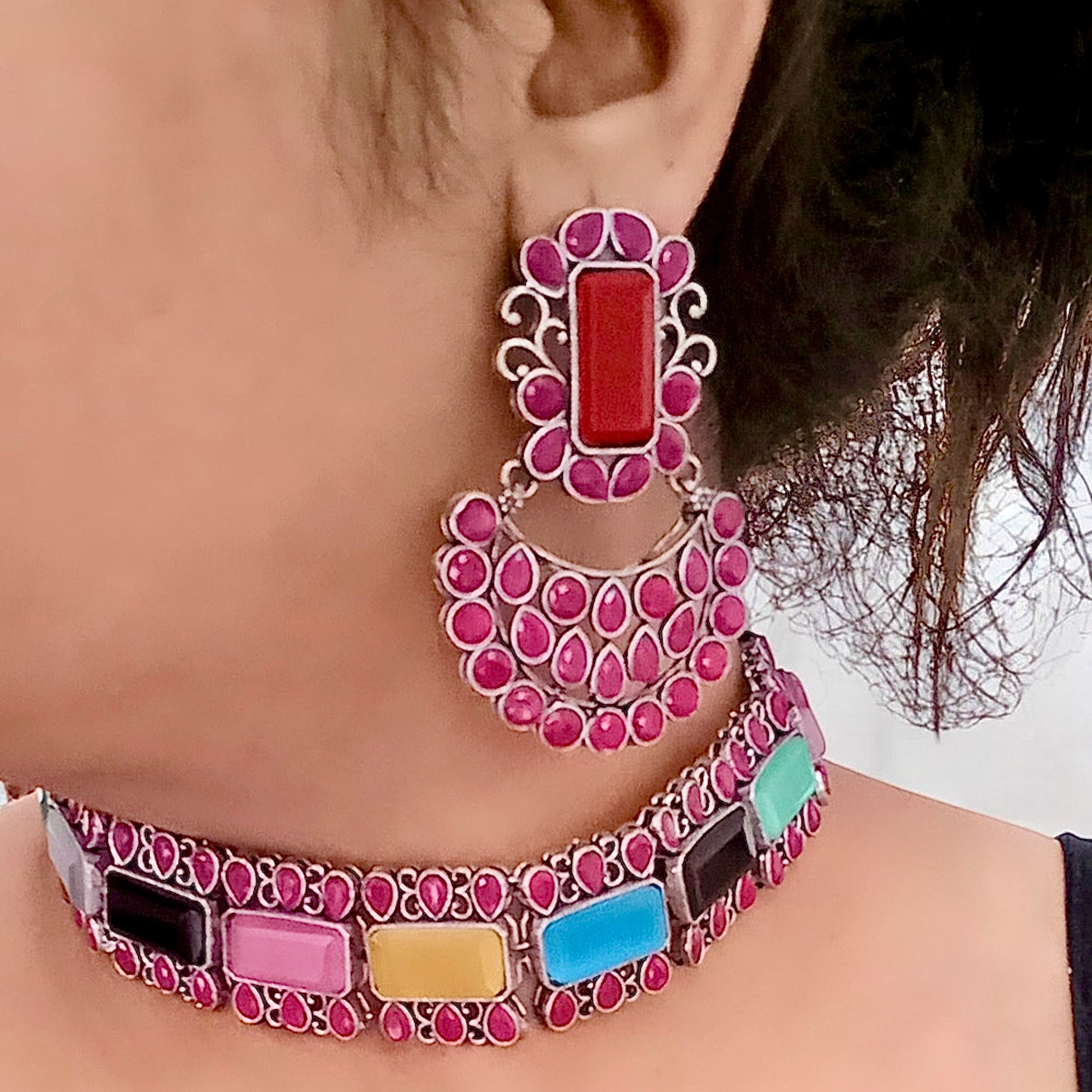 A Model Displaying a Silver Replica Multicolour Choker Necklace featuring vibrant gemstones in pink, blue, yellow, and more, paired with matching Chandbali-style earrings.