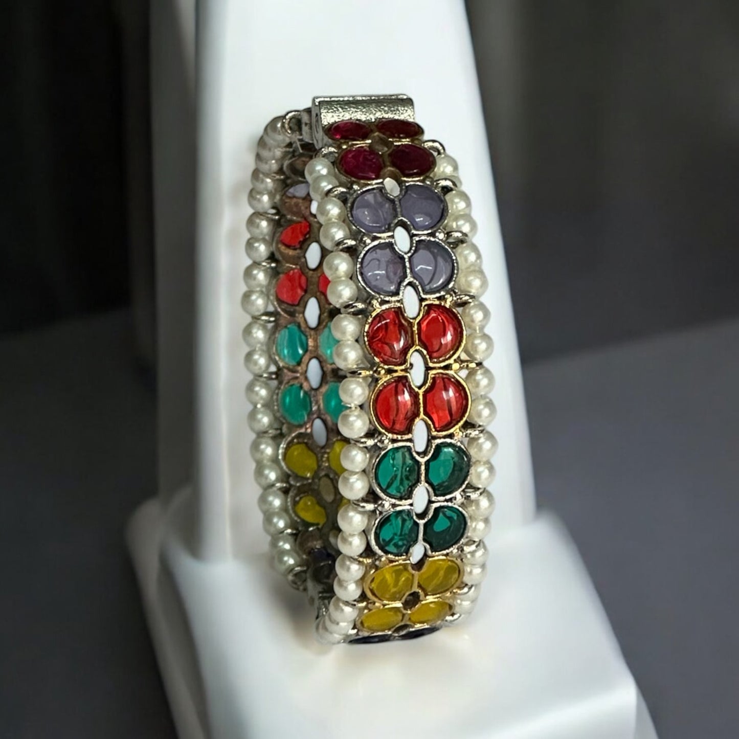 Front view of Silver replica bangle featuring vibrant multicolored enamel floral patterns and delicate pearl accents, displayed on a white background to highlight its intricate craftsmanship.