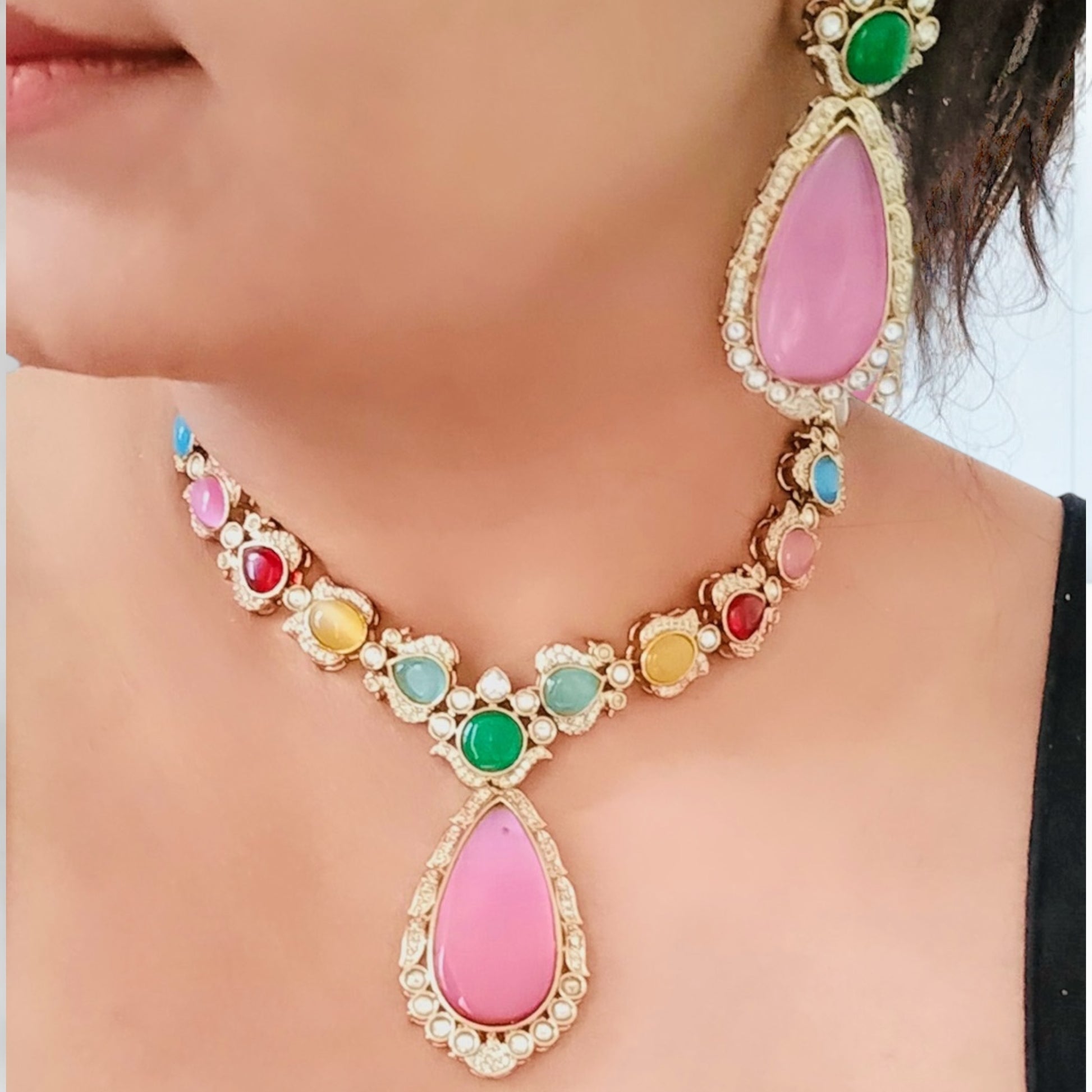 A Model displaying a Statement Multicolor Polki Kundan Necklace with Pink Earrings – featuring a colorful design with intricate Kundan work and bold pink accents.