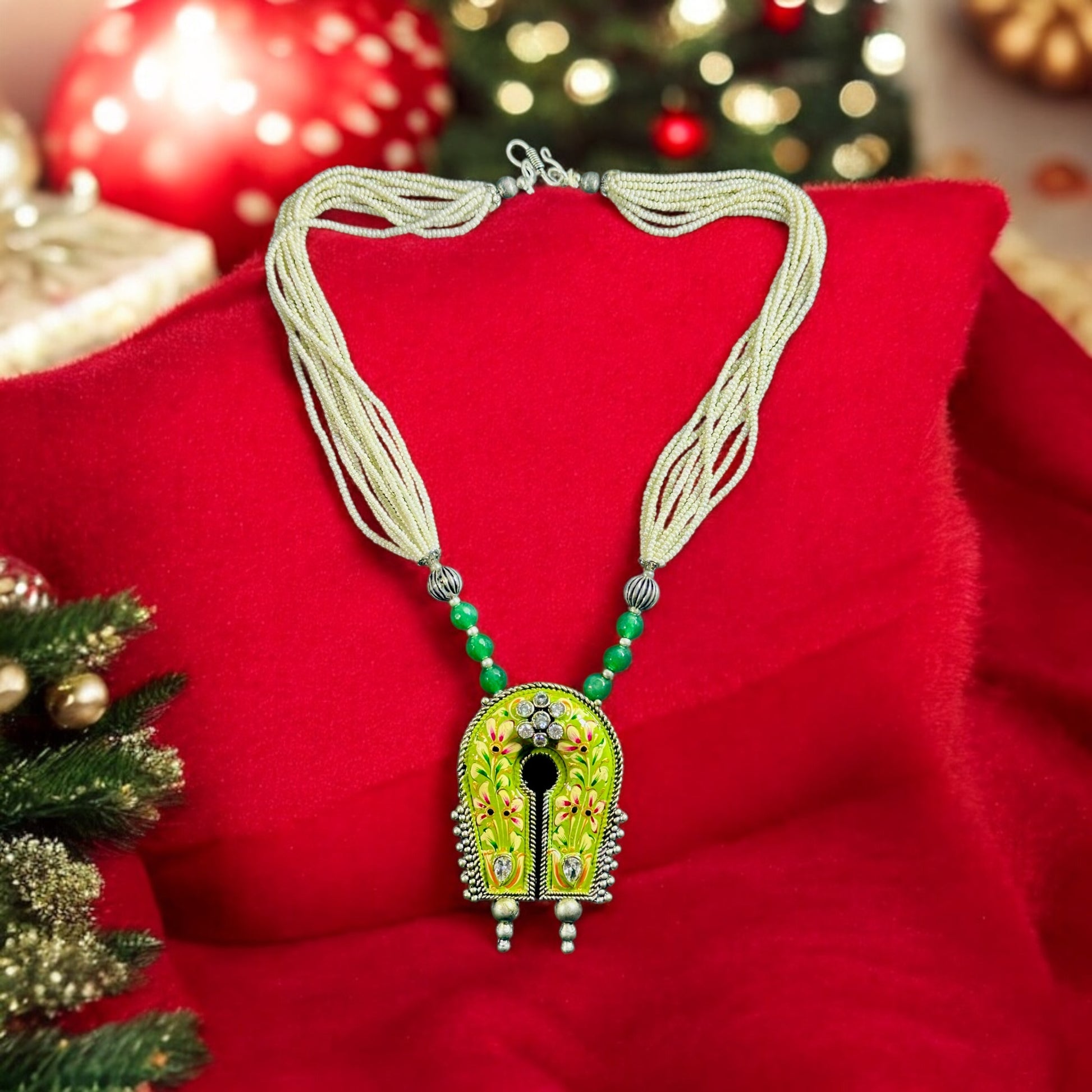 Statement Piece Hand Painted Pendant Silver Look Alike Necklace placed on a santa red colored background.