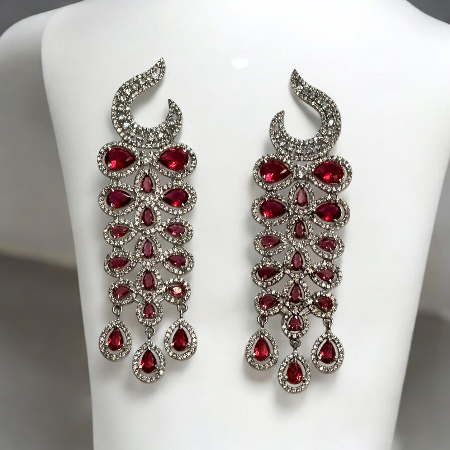 Statement Partywear American Diamond Earrings – stunning cascade earrings with sparkling American diamonds and ruby-red stones. Perfect for weddings, cocktail parties, and festive events.