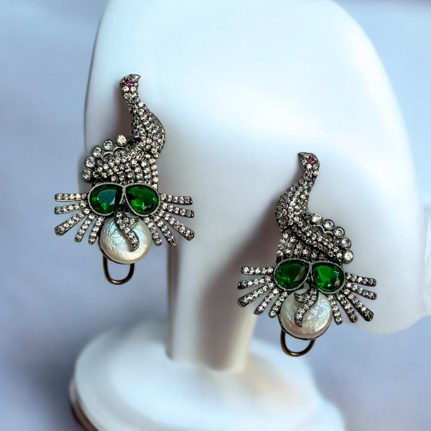 American Diamond Party Wear Earrings – peacock-inspired earrings with green stones, white pearls, and a double-lock mechanism. A stunning choice for festive and formal occasions.