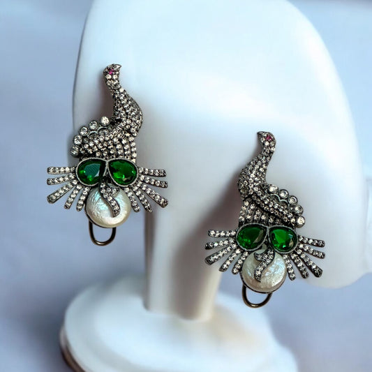 American Diamond Party Wear Earrings – peacock-inspired earrings with green stones, white pearls, and a double-lock mechanism. A stunning choice for festive and formal occasions.