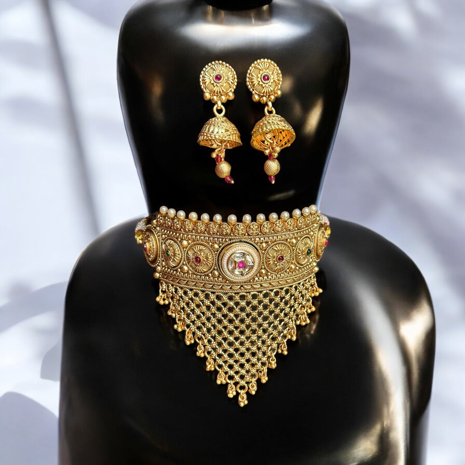 Rajawadi Kundan Choker Necklace with Jhumki Earrings – gold-tone choker with intricate kundan work, pearls, cascading mesh detailing, and matching jhumki earrings. Ideal for weddings and festive occasions.