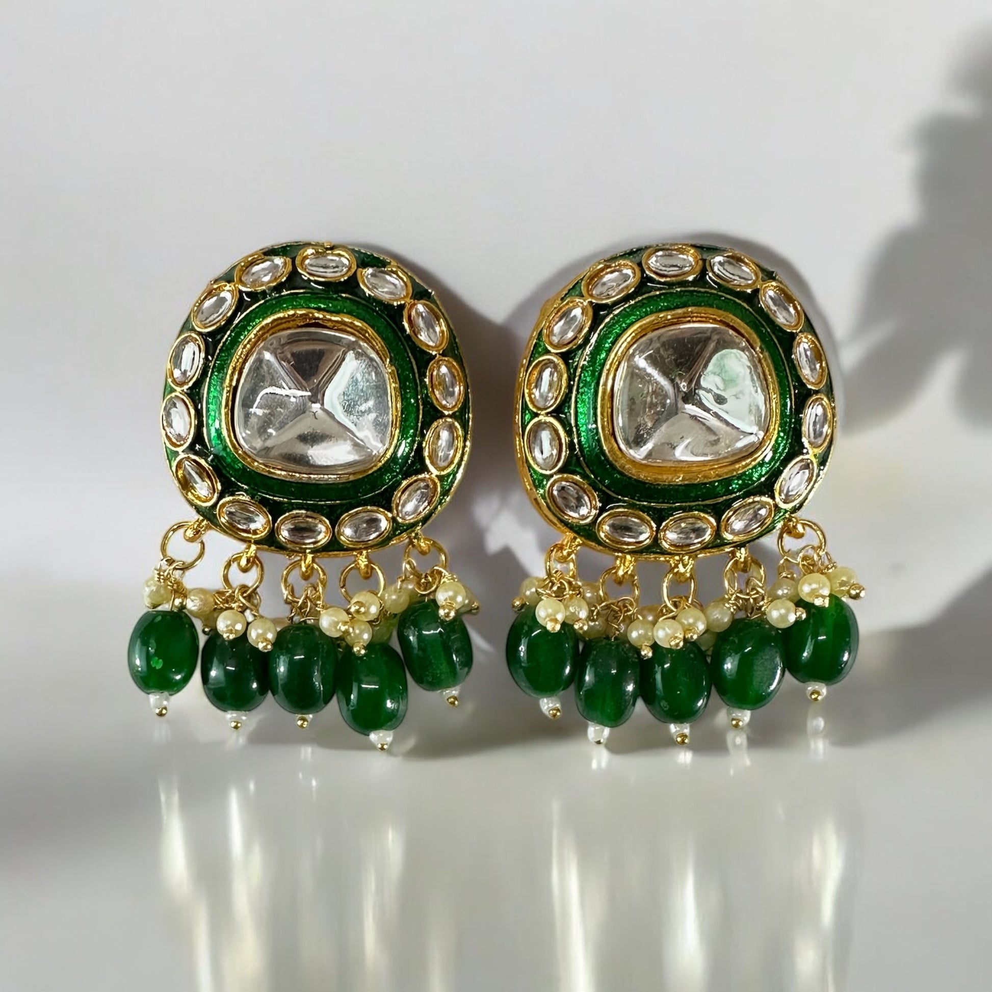 polki kundan statement choker earrings In Green placed on a white colored background.