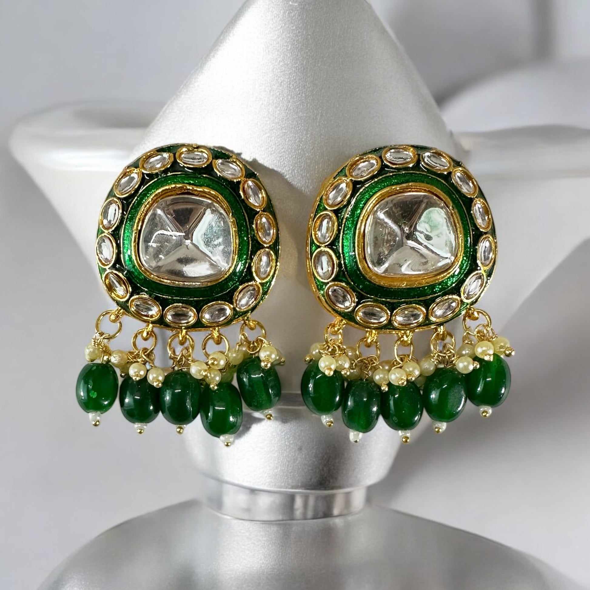 polki kundan statement choker earrings In Green placed on a white colored jewellery display stand.